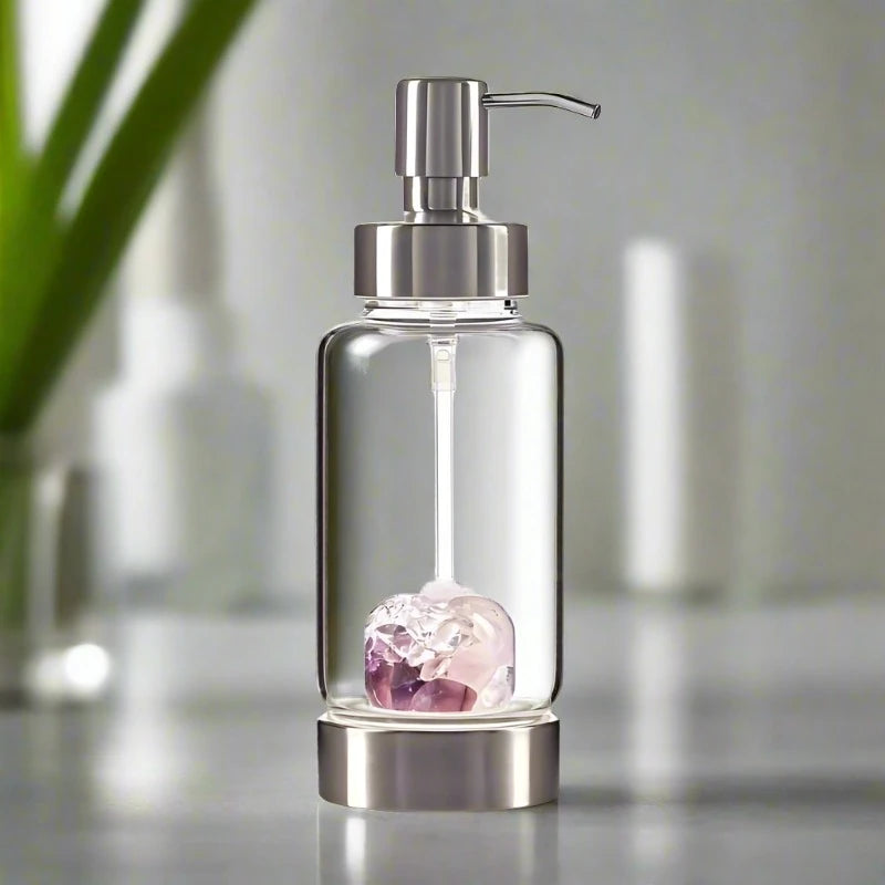 glass soap dispenser with a wellness gemstone blend pod at the base