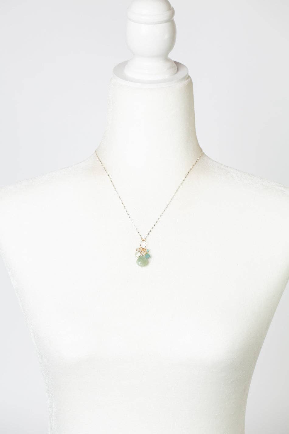 The Blue Apatite, Freshwater Pearl, and Green Amethyst Necklace displayed on a white mannequin, highlighting its adjustable 17-19 inch length and elegant design.