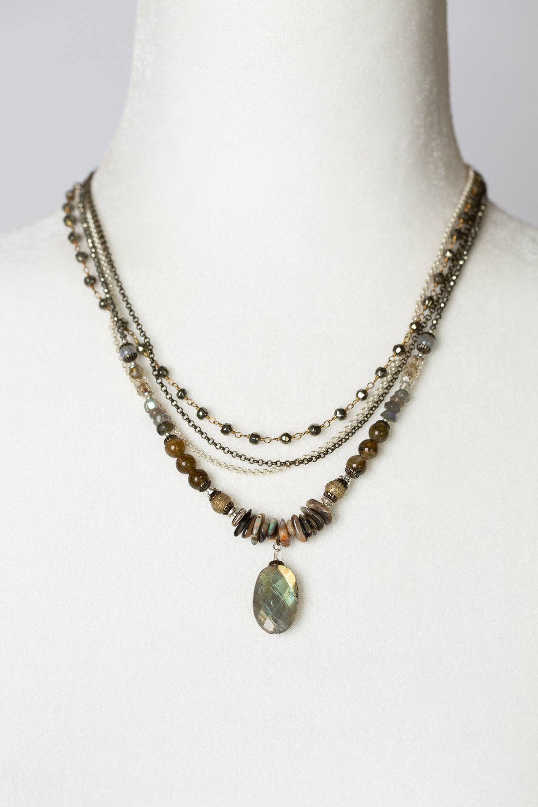 Dunes Collection Multistrand Necklace displayed on a white mannequin bust, highlighting the necklace's layered design and gemstone details.