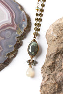 Close-up view of the Herringbone Wrapped Crystal Focal Necklace, featuring the hand-wrapped crystal, chalcedony, and Czech glass accents with antique brass findings.