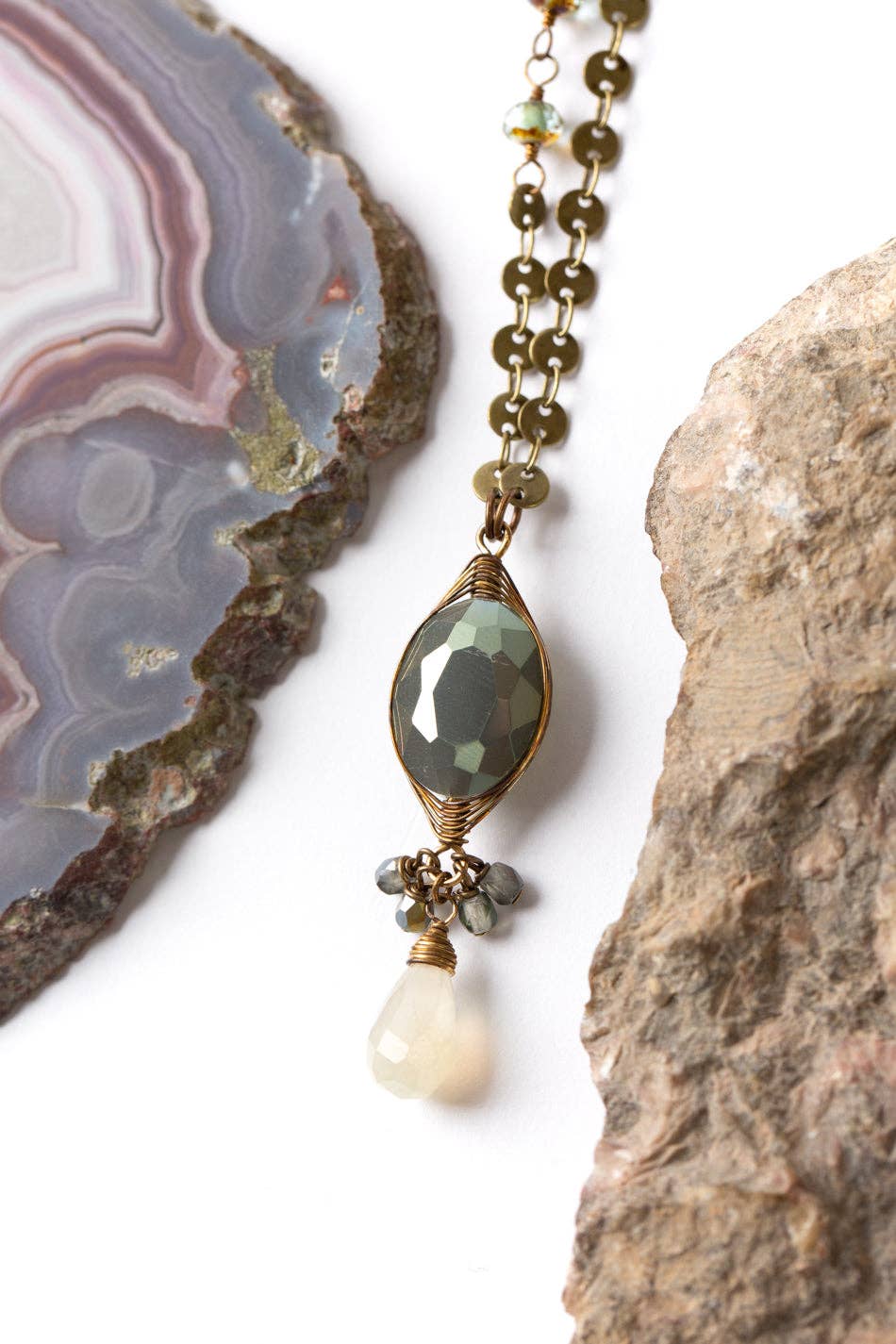 Close-up view of the Herringbone Wrapped Crystal Focal Necklace, featuring the hand-wrapped crystal, chalcedony, and Czech glass accents with antique brass findings.