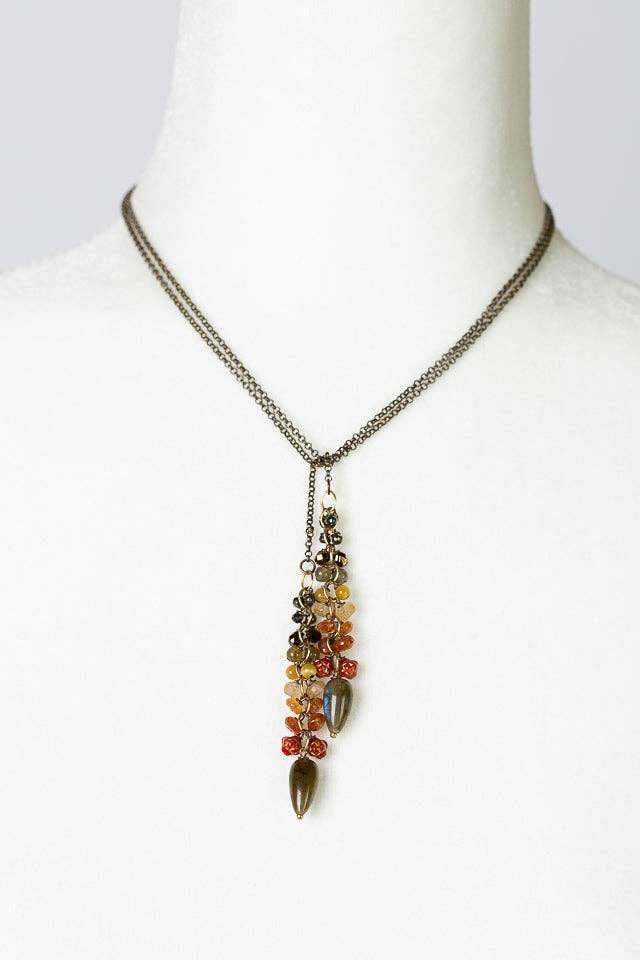 Fireside Collection Lariat Necklace displayed on a white mannequin bust, highlighting the shortened version of the lariat design and gemstone details. 