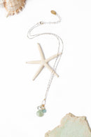 A Blue Apatite, Freshwater Pearl, and Green Amethyst Necklace featuring a hand-wrapped amazonite briolette, displayed on a white background with a starfish.