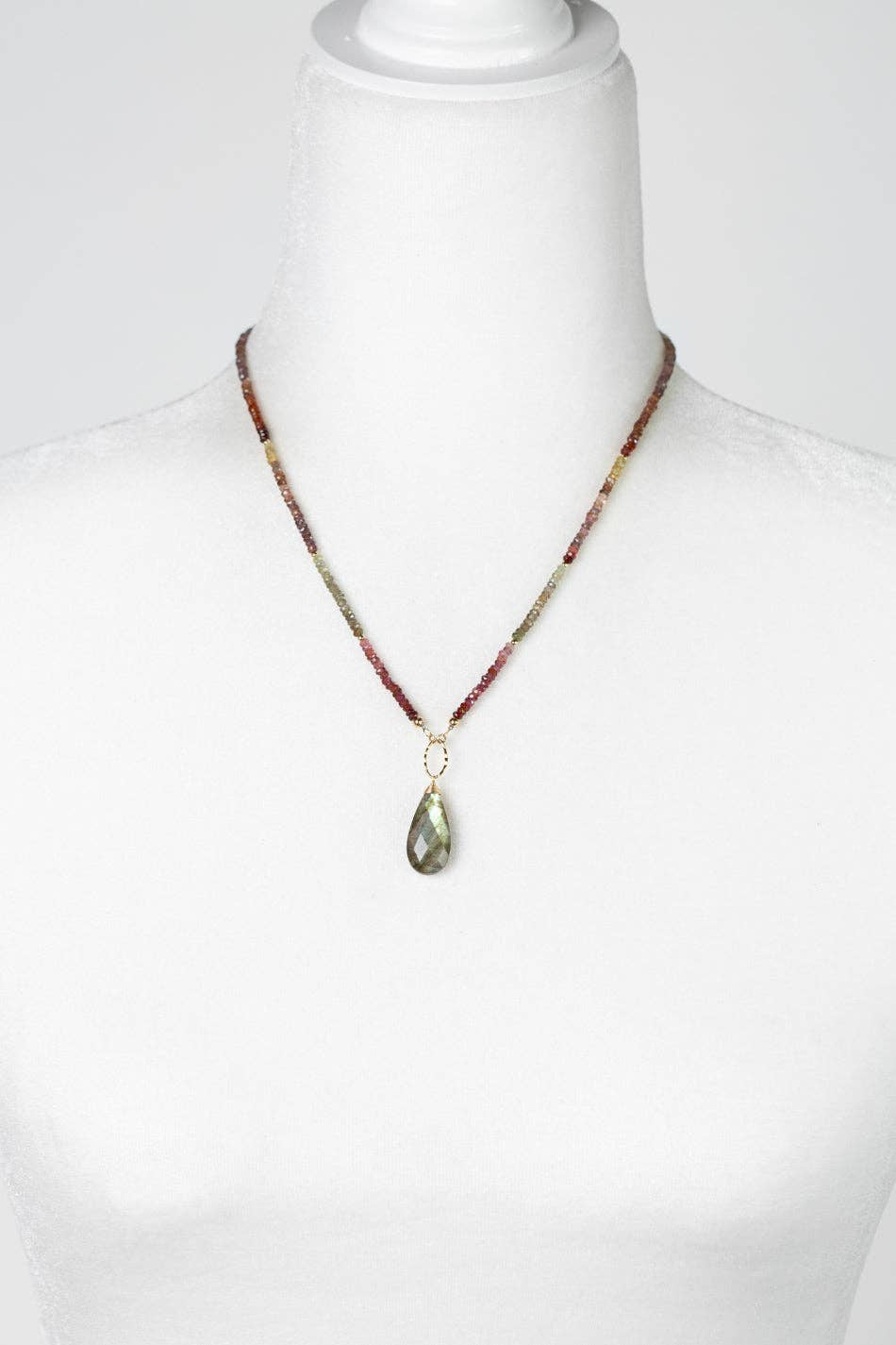 The Faceted Sapphire with Labradorite Teardrop Briolette Statement Necklace displayed on a white mannequin, highlighting its adjustable 19-21 inch length.