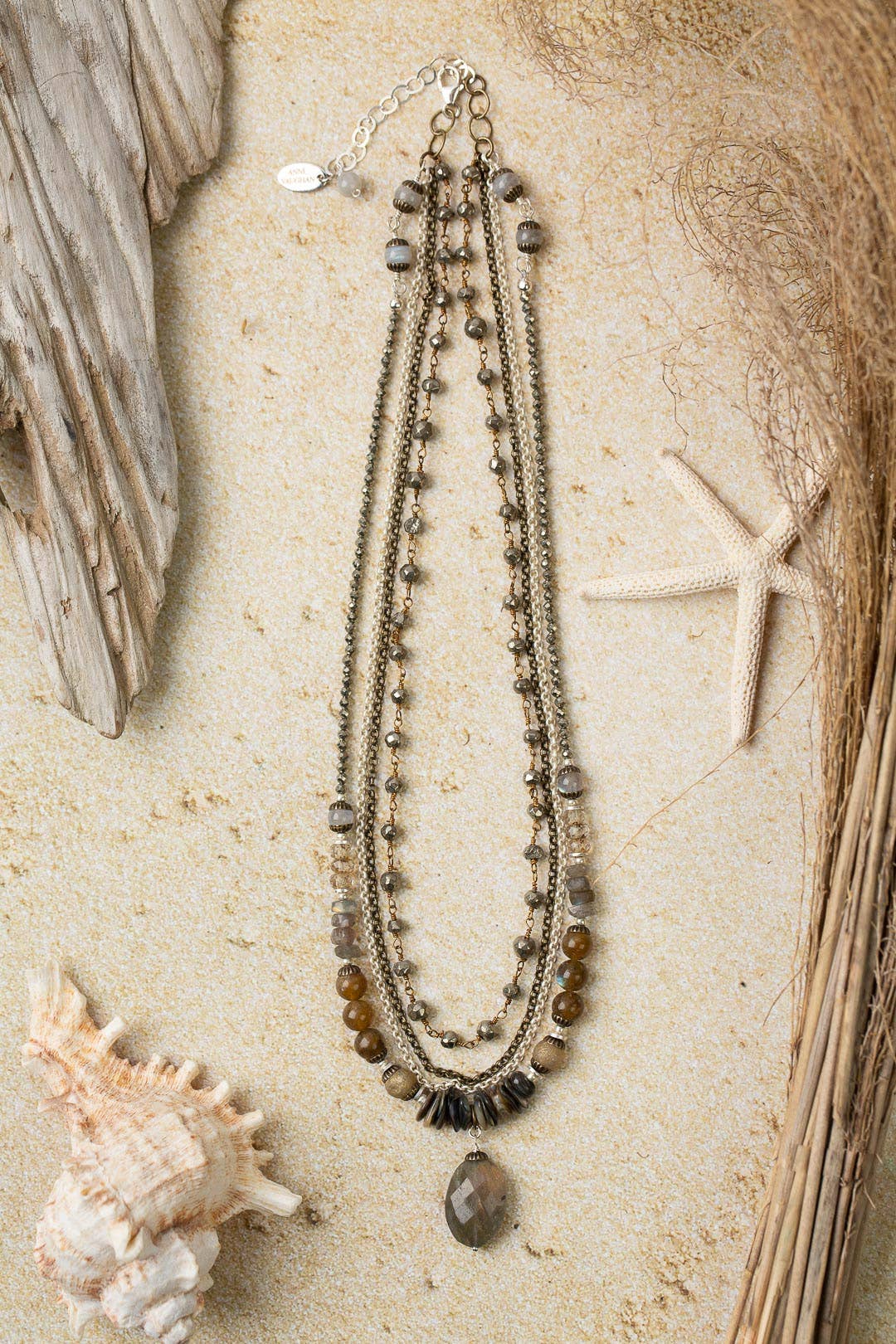 Full view of the Dunes Collection Multistrand Necklace laid flat, featuring Czech glass, abalone, labradorite, and a sterling silver extender chain with a lobster claw clasp.