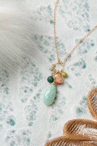 Close up of a A Chrysocolla, Olive Jade & Amazonite Necklace featuring a soft colorway with a beautiful amazonite focal, displayed on a textured background.