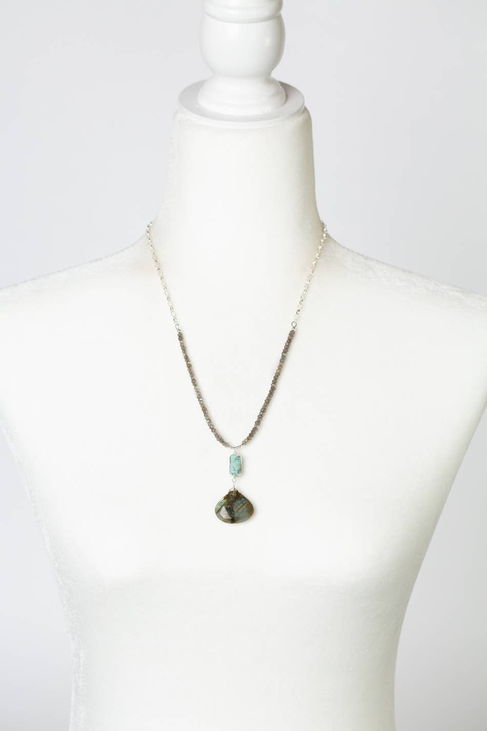 The Mystic Collection necklace displayed on a white mannequin, showcasing its adjustable 20-22 inch length and the elegant combination of labradorite and turquoise.