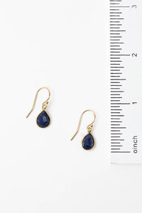 Close-up view of Teardrop Lapis Bezel Earrings with gold-filled settings and ear wires, shown next to a ruler for size reference.