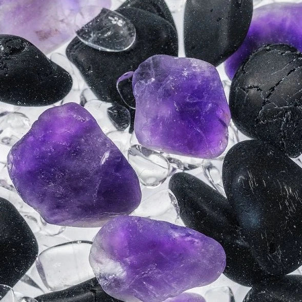 Close-up view of the Guardian gemstones including black tourmaline, amethyst, and clear quartz.