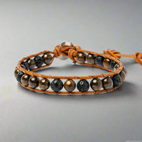 Front view of an adjustable bronzite & lava stone bracelet