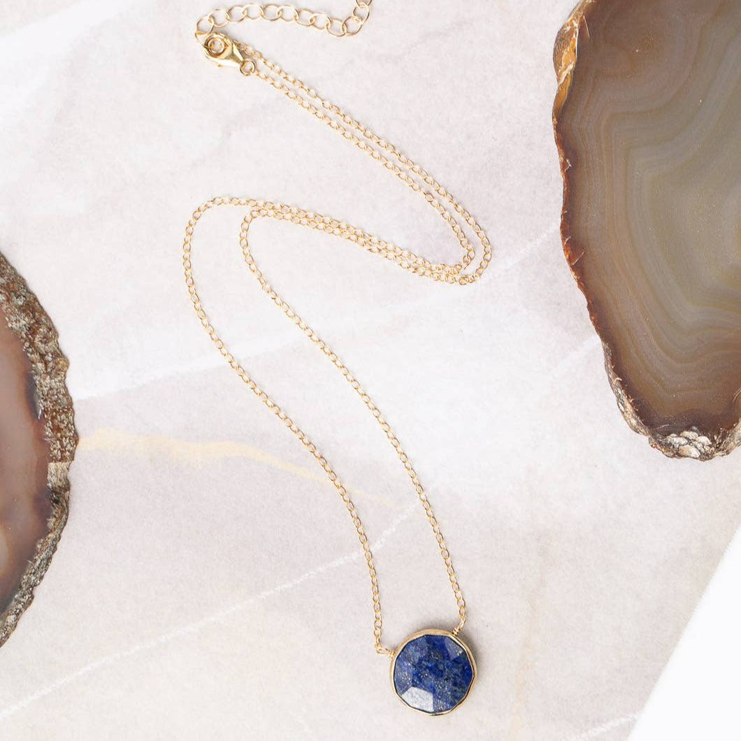 gold chained necklace with a single lapis stone