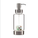 Glass spa dispenser with gemstone pod at the base,