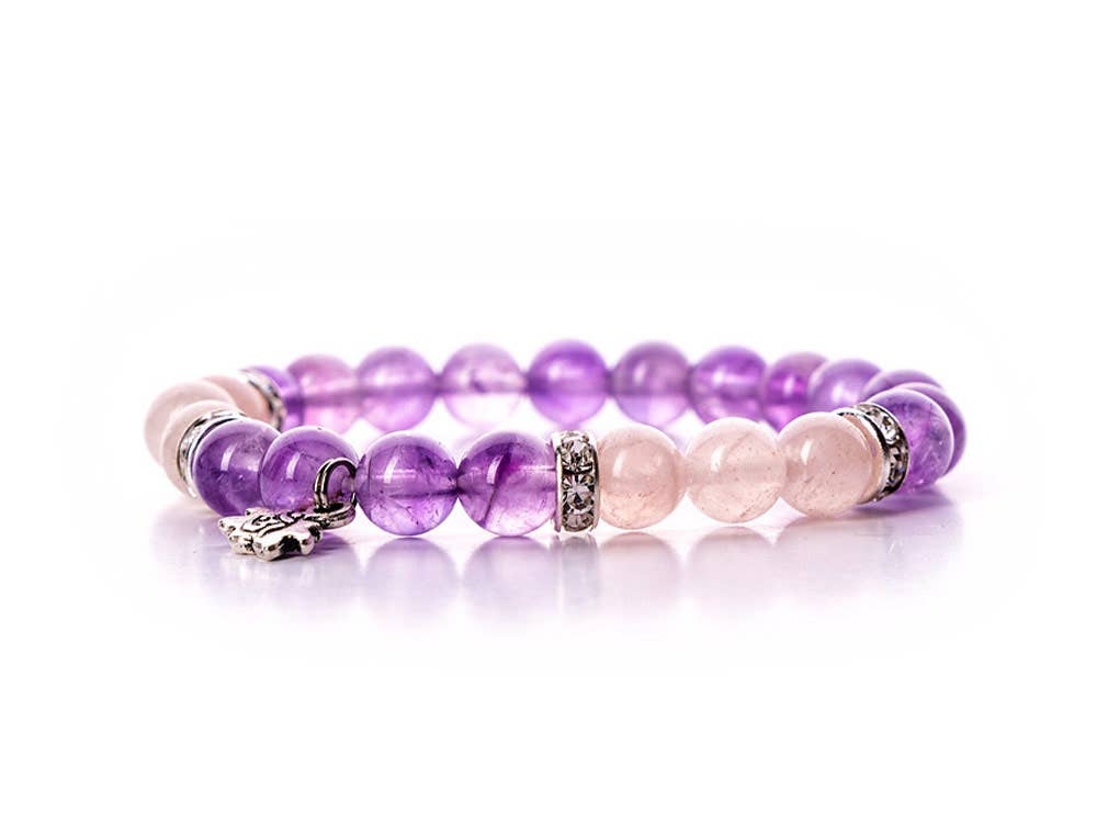 Close-up view of the Amethyst and Rose Quartz Tranquility Bracelet. The bracelet features Amethyst stones for mind stimulation and emotional soothing, and Rose Quartz stones for tranquility and harmony.