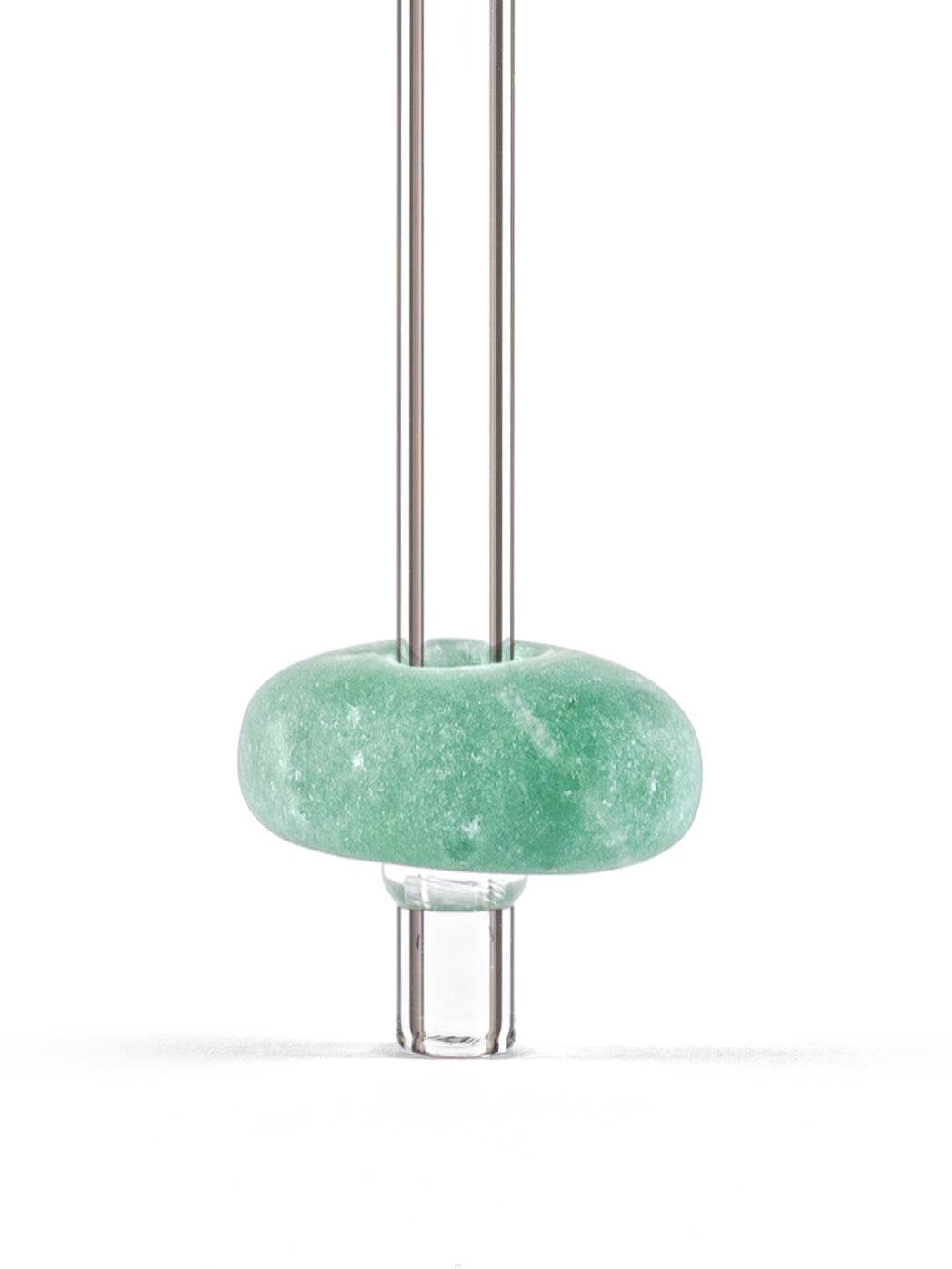 Close-up view of a glass straw with an aventurine gemstone attached, showcasing the vibrant colors and unique textures of the stone.