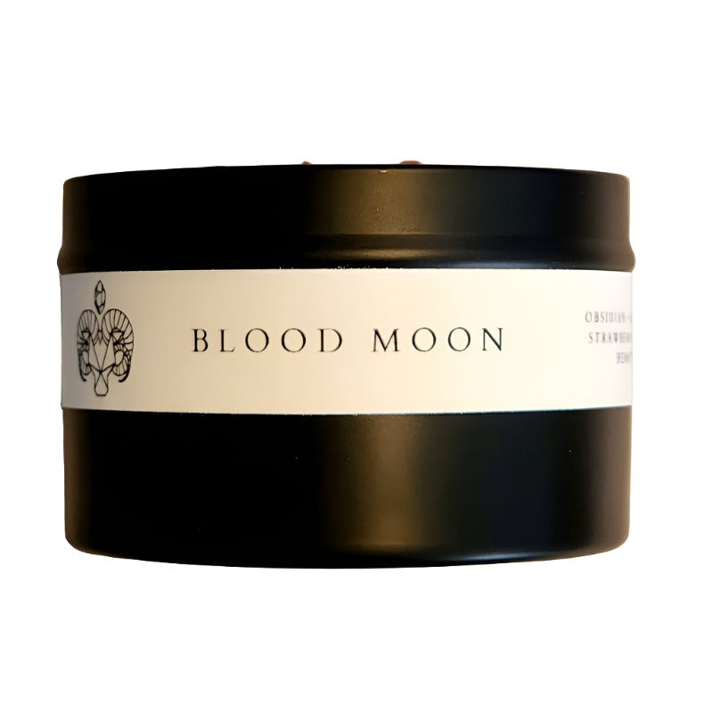 Side view of the 8oz Soy Crystal Intention Candle Blood Moon showing the label with Obsidian, Red Jasper, Strawberry Quartz, and Hematite crystals. Scented with Tobacco and Blood Orange.