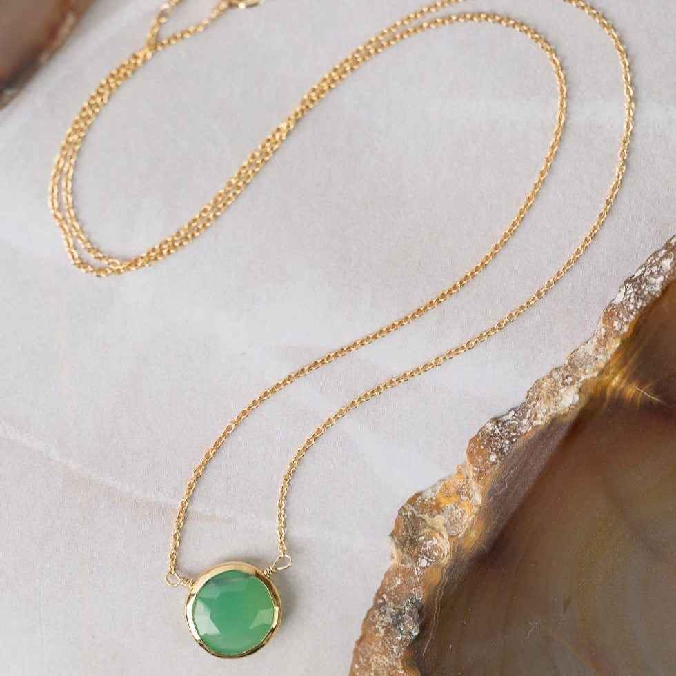 simple gold necklace with a single chrysoprase stone