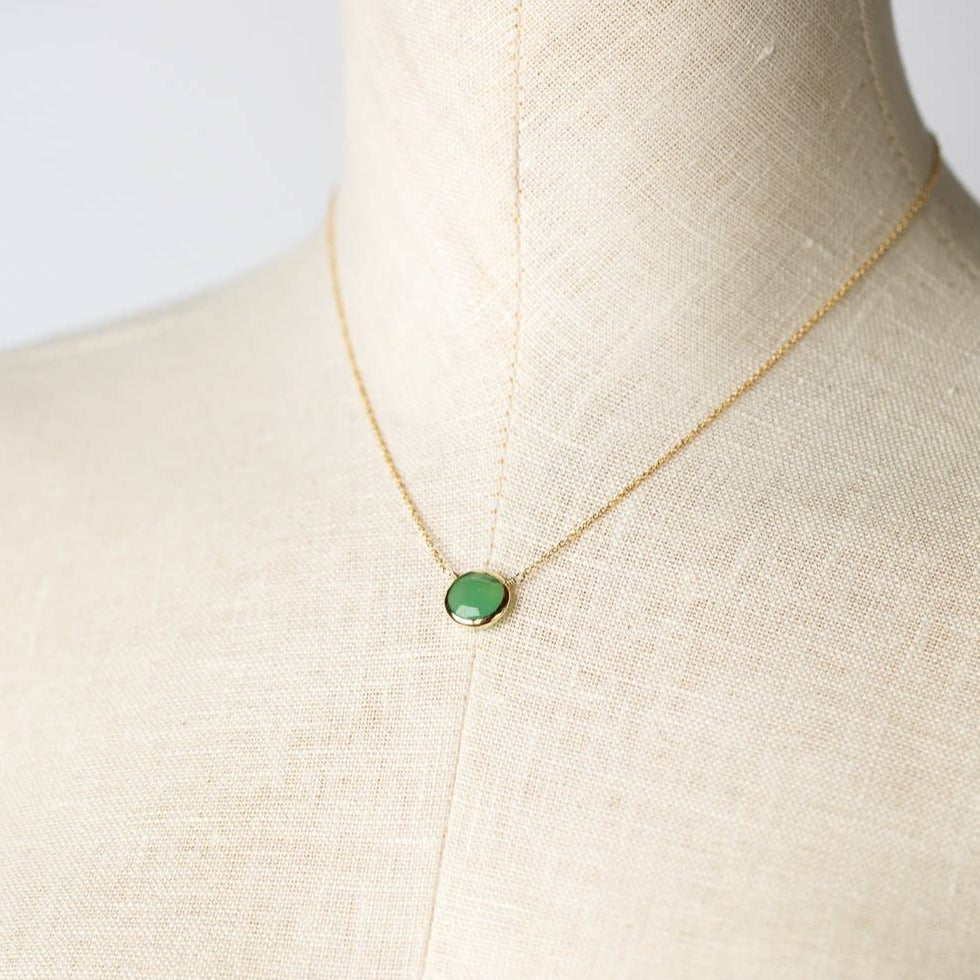 simple gold necklace with single chrysoprase stone