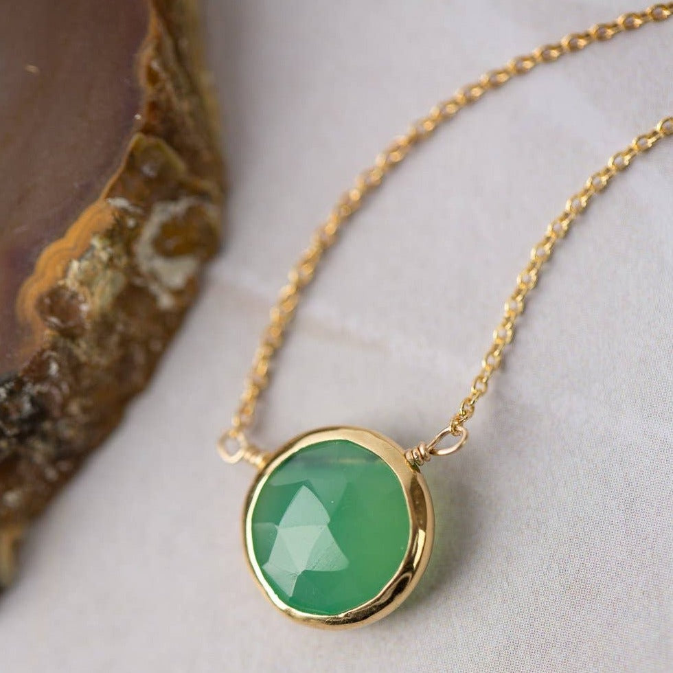 simple gold necklace with a single chrysoprase stone