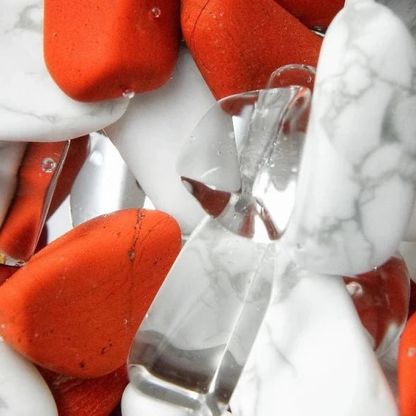 Close-up view of the Fitness gemstones including red jasper, magnesite, and clear quartz.