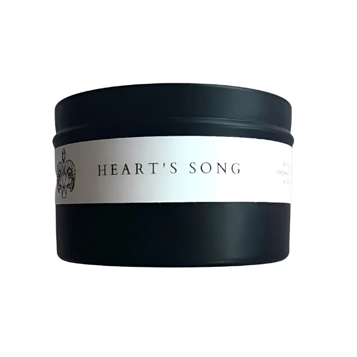 Side view of the 8oz Soy Crystal Intention Candle Heart's Song showing the label with Rose Quartz, Prehnite, Citrine, and Aura Quartz crystals. Scented with Grapefruit and Ginger.