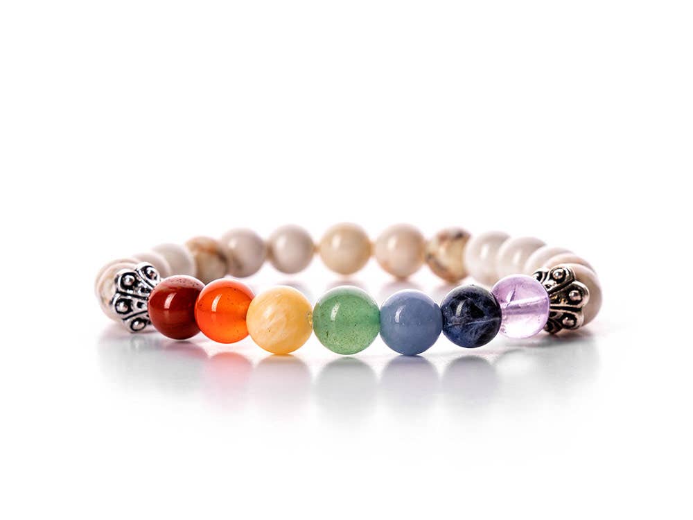 Close-up view of the Howlite and Chakra Stone Bracelet featuring 8mm beads. The bracelet is adorned with vibrant chakra stones for holistic well-being.