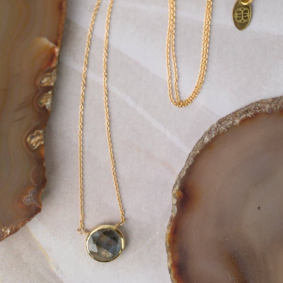 simple gold necklace with a single labradorite stone