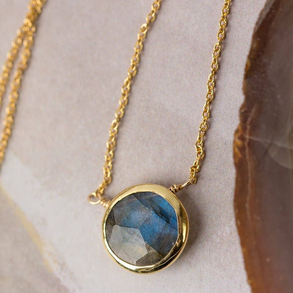 simple gold necklace with a single labradorite stone