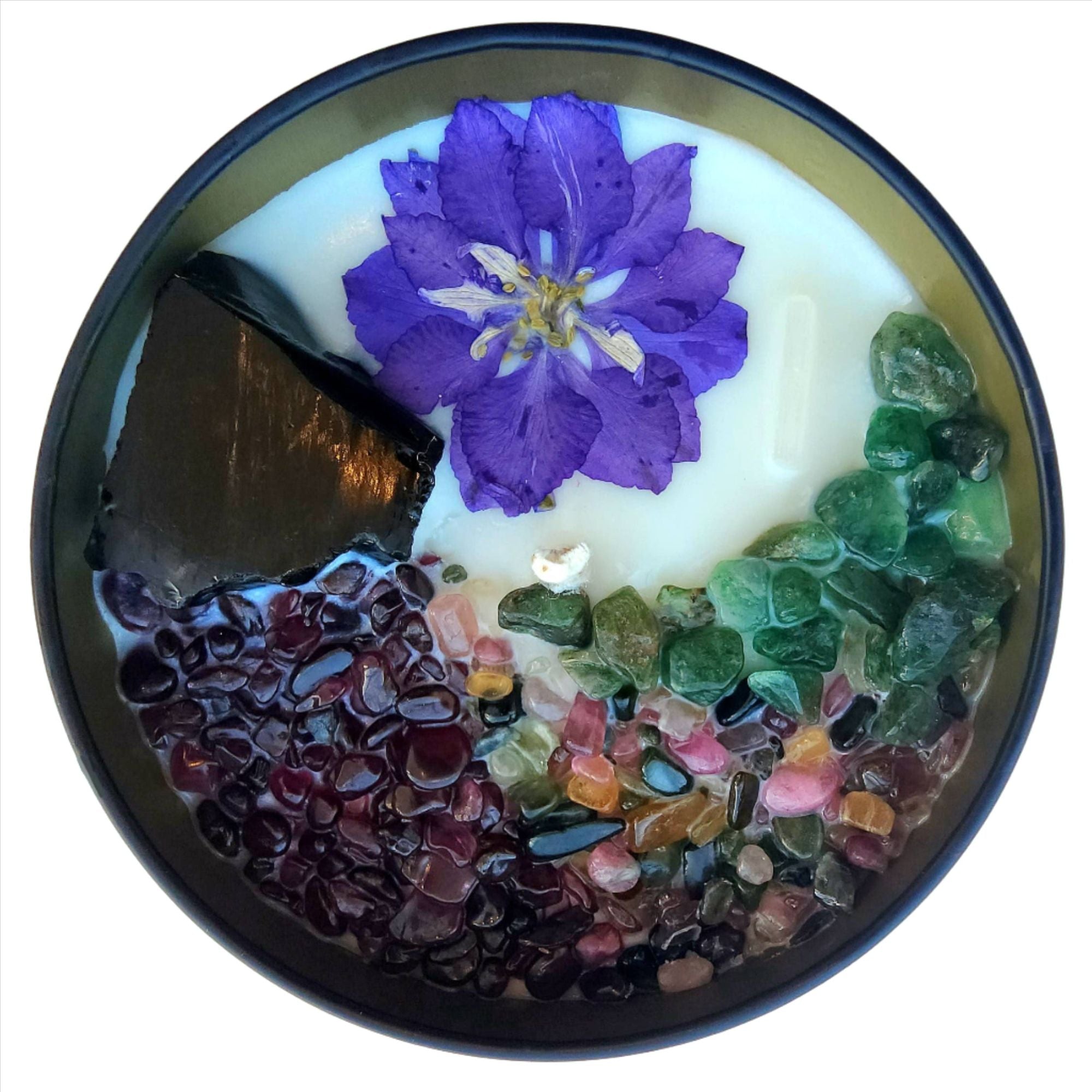 Top view of the 8oz Soy Crystal Intention Candle Persephone (Queen of the Underworld) with Black Obsidian, Garnet, Mixed Tourmaline, and Emerald crystals. Scented with Saffron, Black Violet, and Moss.