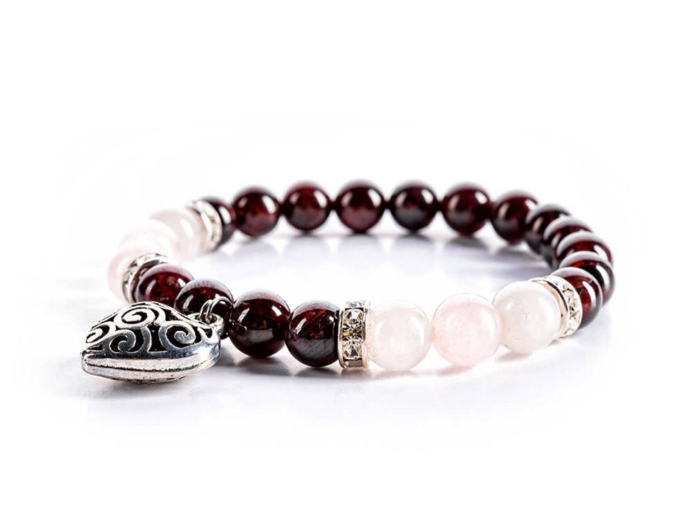 Close-up view of the Rose Quartz and Garnet Harmony Bracelet. The bracelet features Rose Quartz beads, known for love and tenderness, and Garnet beads for sensuality and passion.