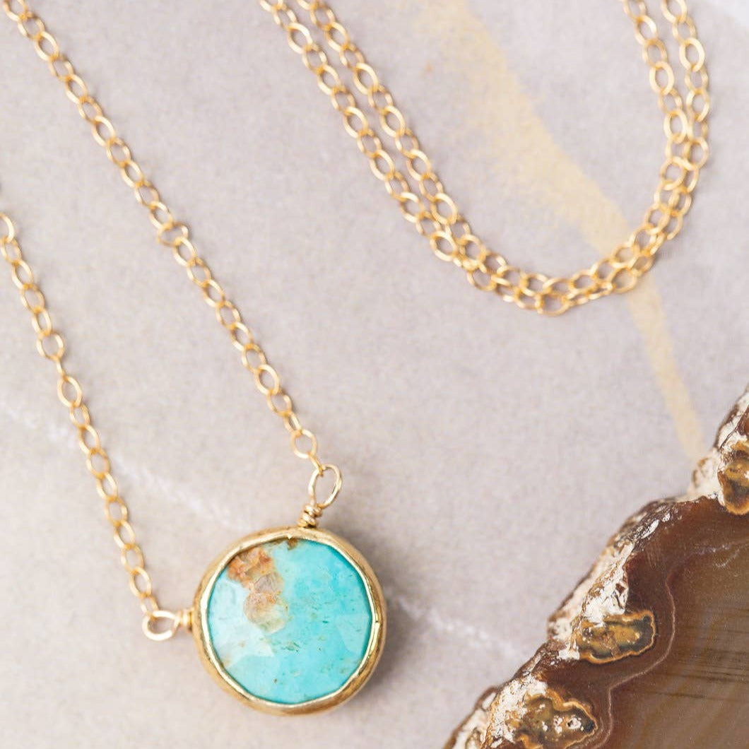 simple gold necklace with single turquoise stone