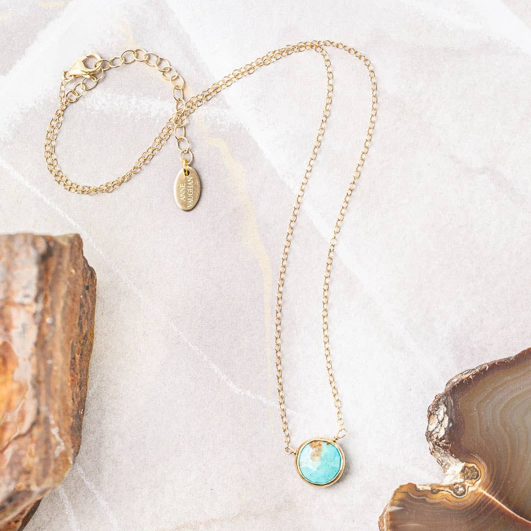 simple gold necklace with a single turquoise stone