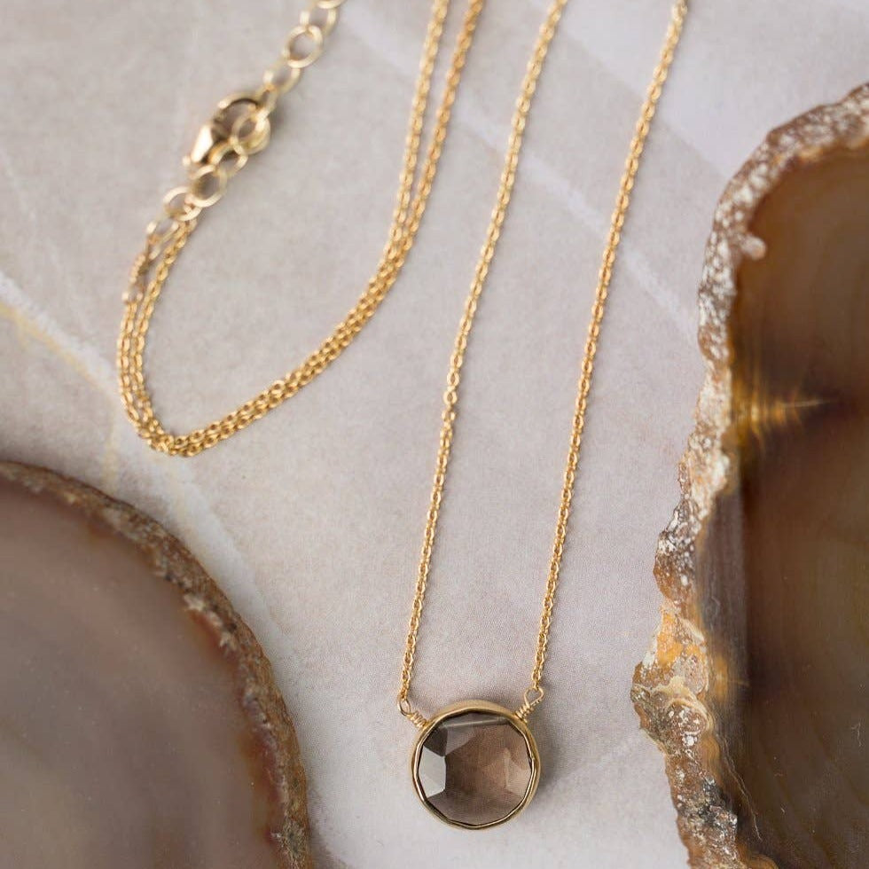 simple gold necklace with a single smoky quartz stone