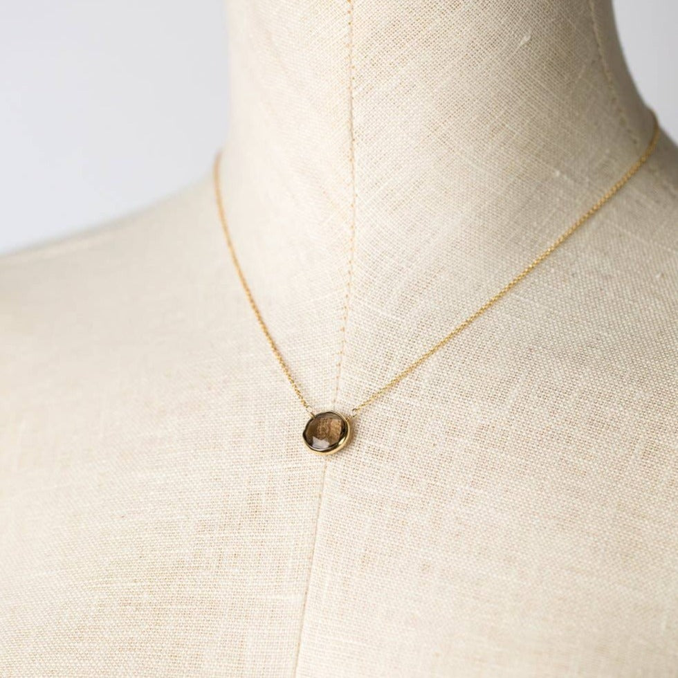 simple gold necklace with a single smoky quartz stone