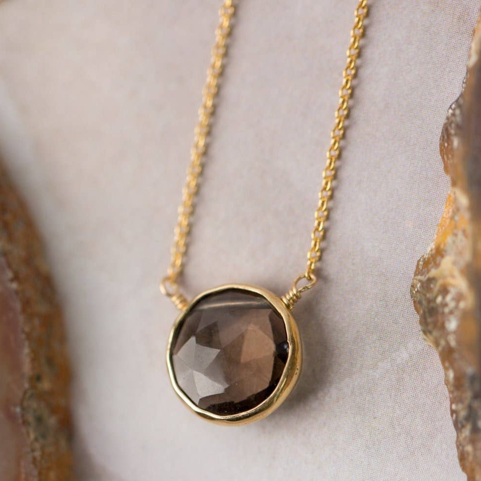 simple gold necklace with a single smoky quartz stone